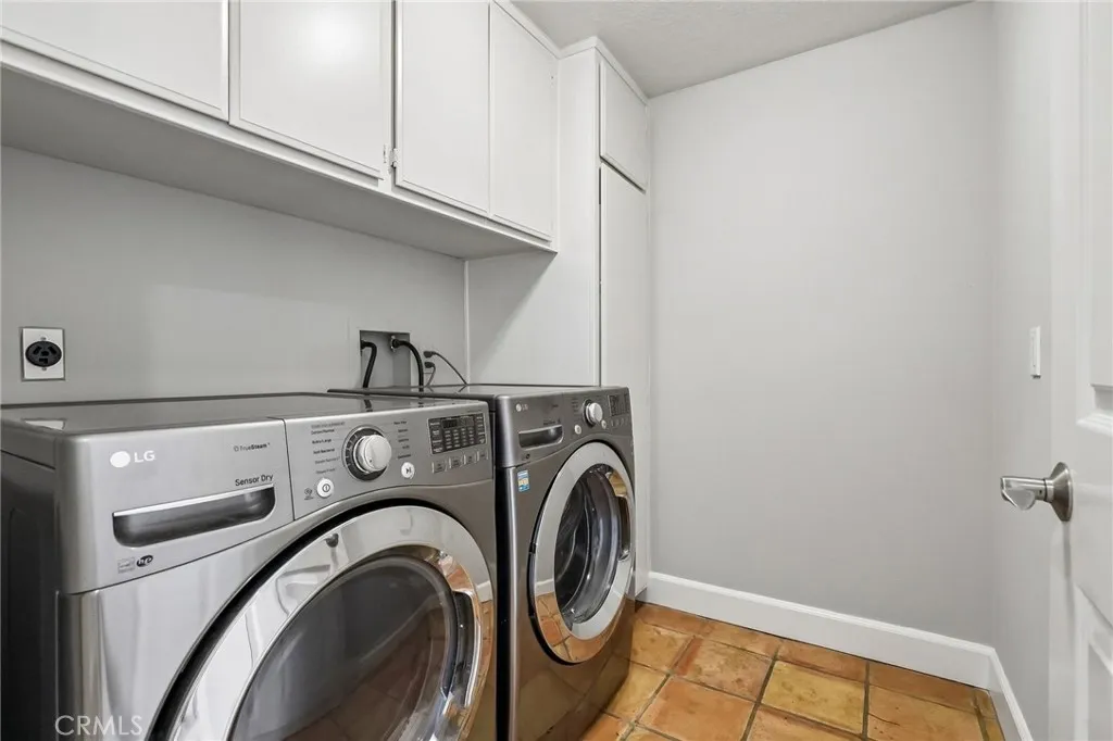 Spacious main level laundry room with ample storage.