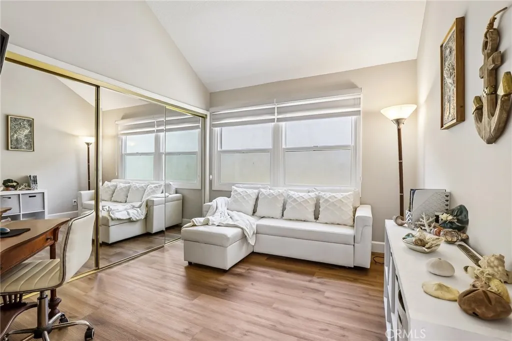 Guest Room 1 is set up as an office with a convertible sofa, Custome Zebra Blinds &California Closets