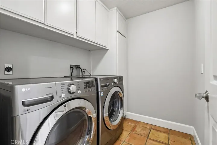 Spacious main level laundry room with ample storage.