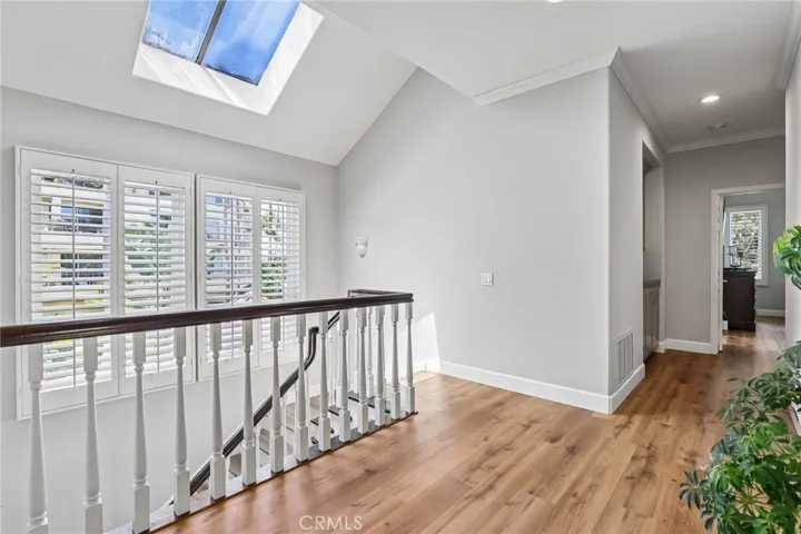 Second Level with an open landing, skylight and large windows with plantation shutters and luxury vinyl flooring.