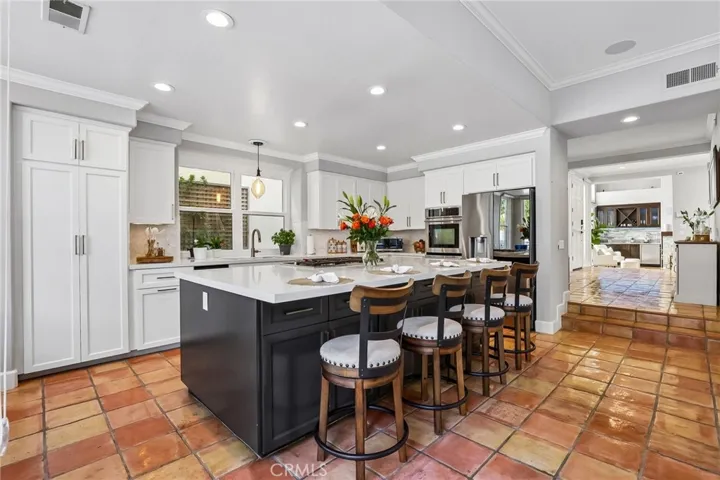 The Island and Kitchen feature ample storage and a pantry with pull-out shelving