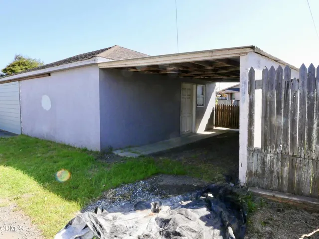 Back House. Exterior Rear with Carport
