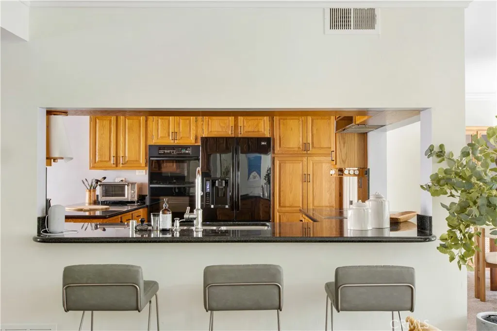 Another view of breakfast bar and kitchen from family room.