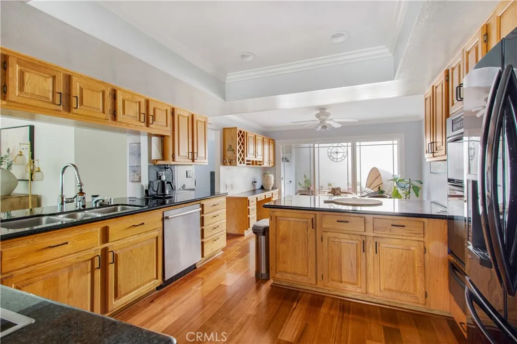 Another view of kitchen leading into 2nd dining area and built in desk in 2nd dining area space.