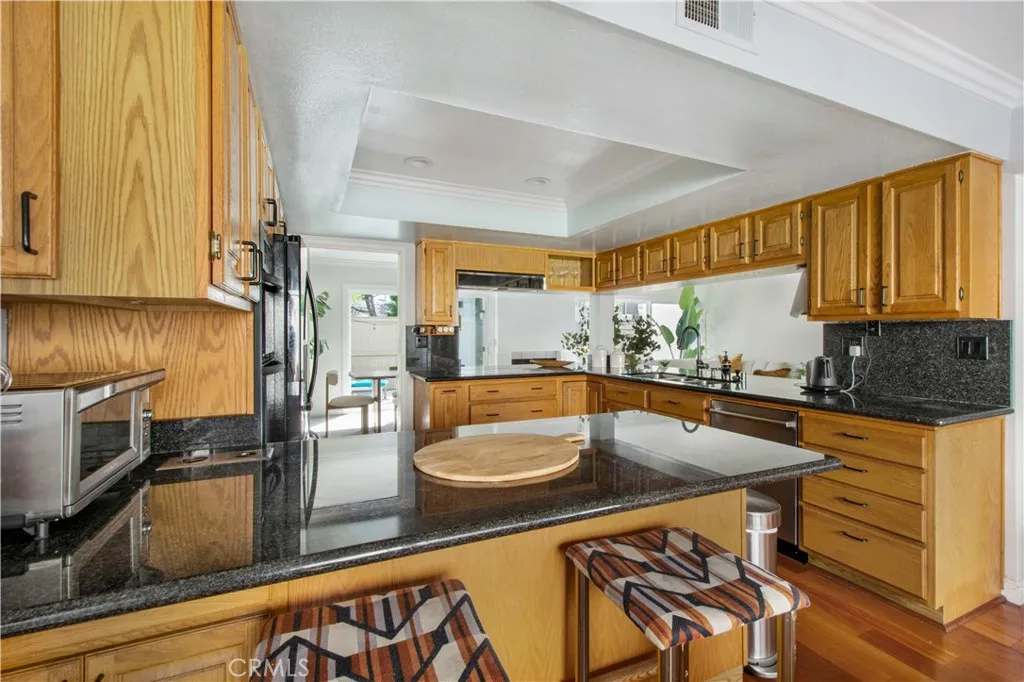 View of 1 of 2 breakfast bar areas from 2nd dining area into kitchen.