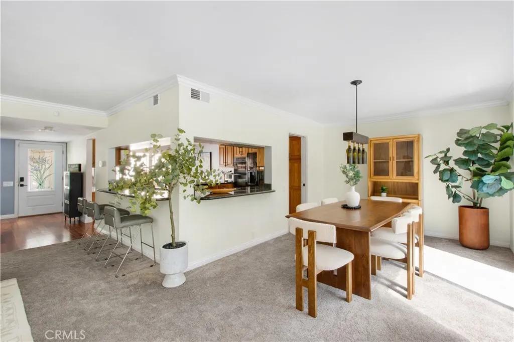 Another view of family room, breakfast bar, kitchen and dining room.
