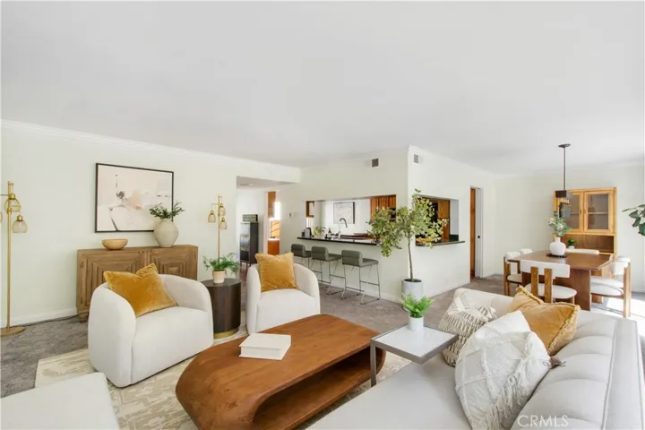 Another view of the family room, breakfast bar, kitchen and dining room.