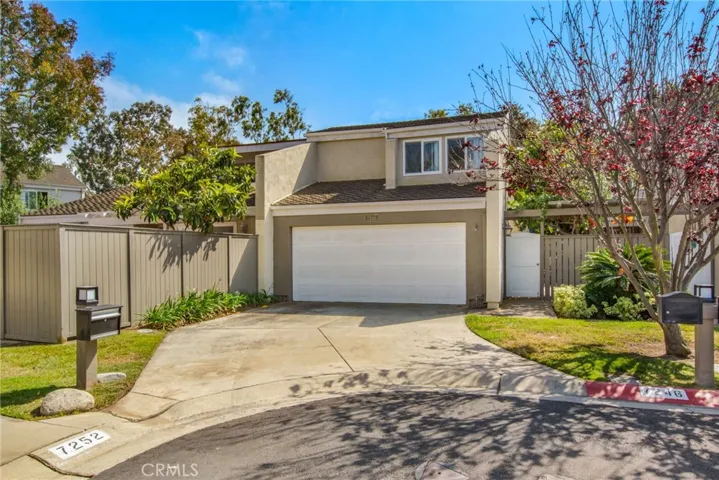 Front of 2 story home including 2 car garage and side gate entry at cul-de-sac.