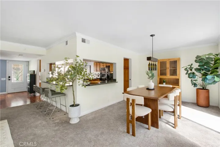 Another view of family room, breakfast bar, kitchen and dining room.