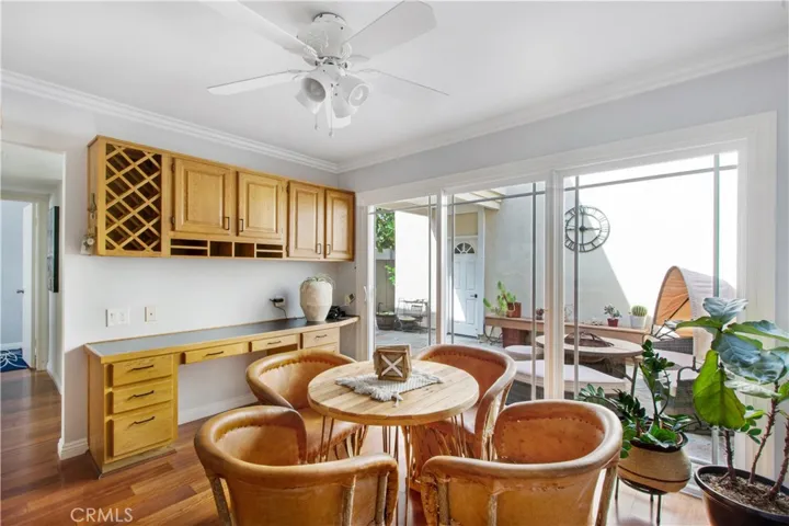 2nd dining area including built in desk and additional cabinetry above desk and dual pane slider leading into front patio.