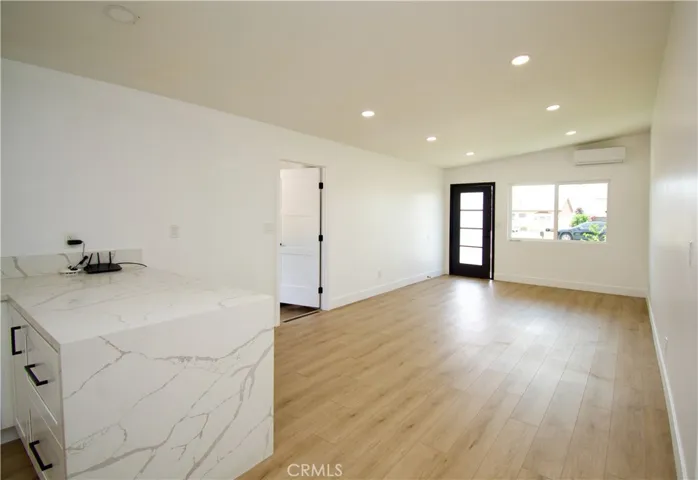 Breakfast bar opens to dining & living room