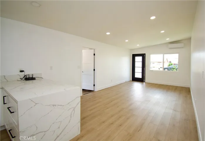 Breakfast bar opens to dining & living room