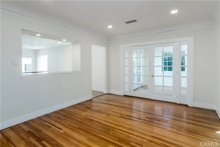 Dining room with French doors to sunroom and outdoor deck.  Kitchen to the left with pass-through opening