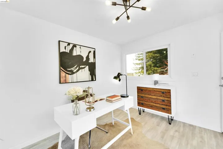 Bright room featuring light-toned wood-finish flooring and white walls