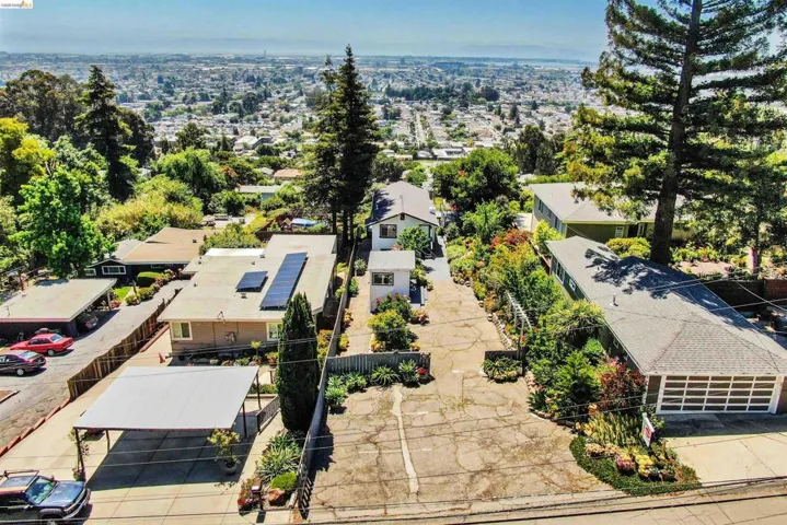 Expansive property with multiple buildings, paved parking areas, and mature landscaping