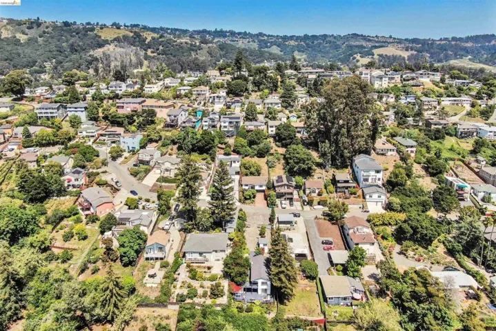 Terraced hillside community featuring multiple residential properties with varied architectural styles