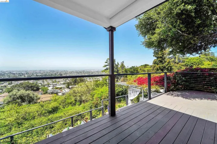 Spacious deck with cable railing and expansive cityscape panorama