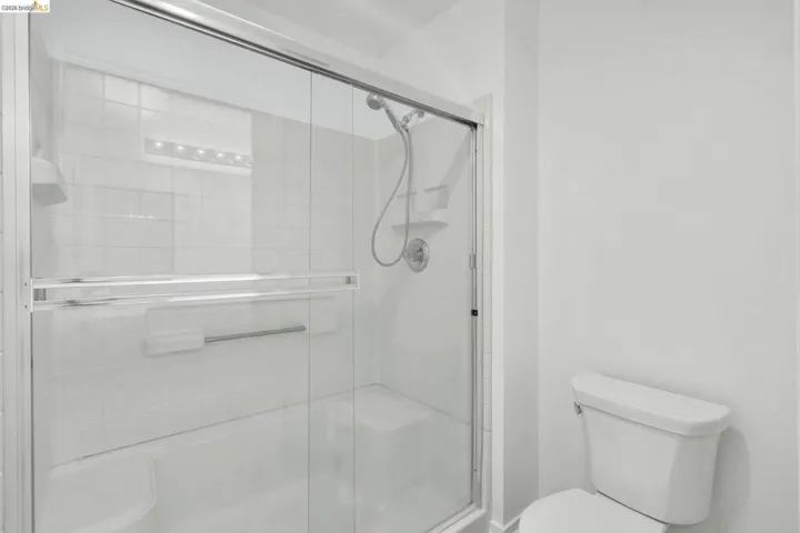 Shower-tub combination with clear glass enclosure and sliding door