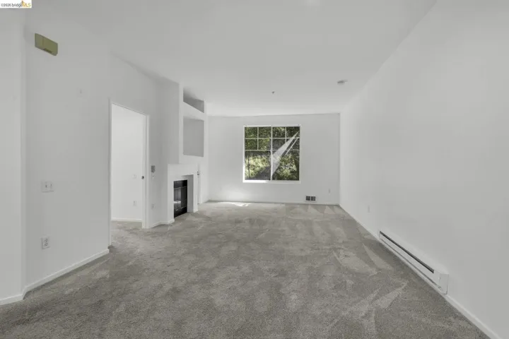 Living area with light gray carpeting and white walls