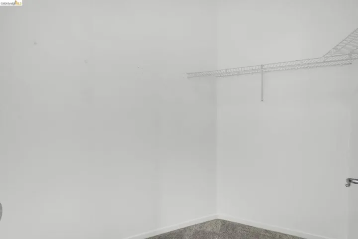 Corner closet featuring white wire shelving