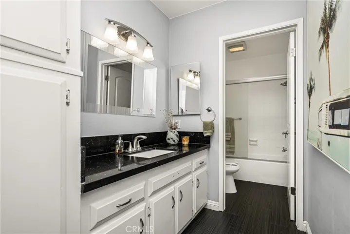 bathroom updated with dramatic quartz countertops and fixtures