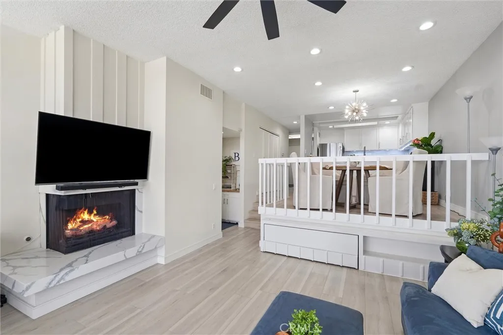 Fireplace digitally enhanced and is operable during limited months per HOA