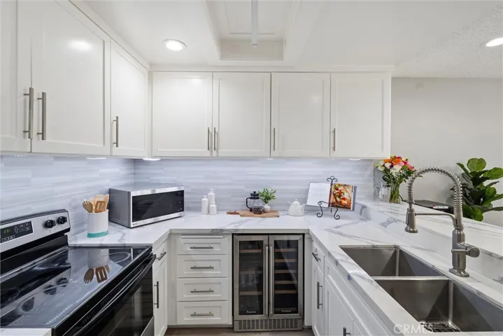 Kitchen open to dining area complete with a wine fridge.