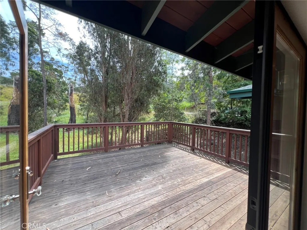 Deck off of dining area, surrounded by forest