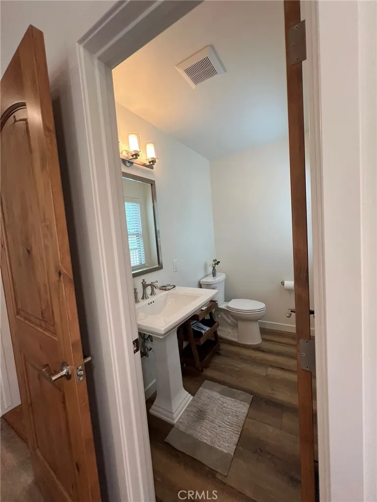 Powder room on living level next to family room entrance