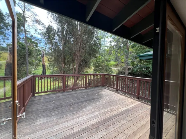 Deck off of dining area, surrounded by forest