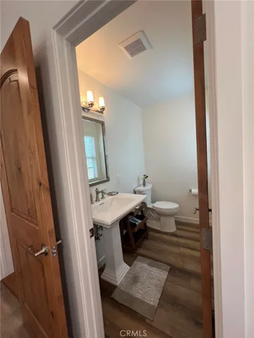 Powder room on living level next to family room entrance