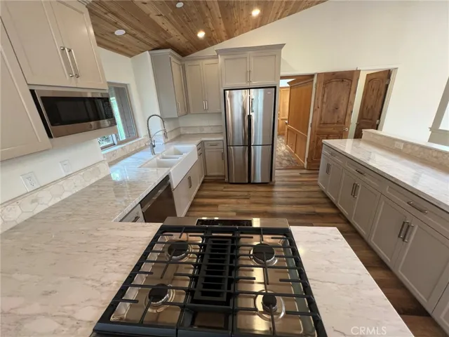 Gas cook top, new fridge, dishwasher and microwave.