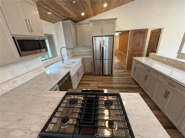 Gas cook top, new fridge, dishwasher and microwave.