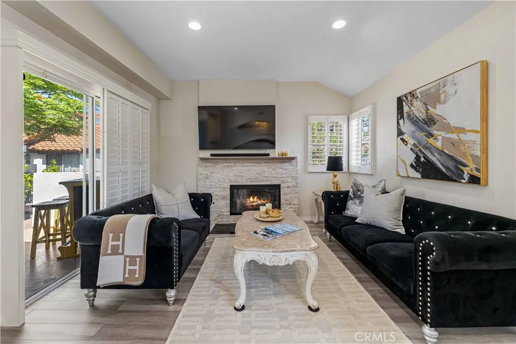 Contemporary Living Space with updated Stacked Stone Fireplace and Patio Access