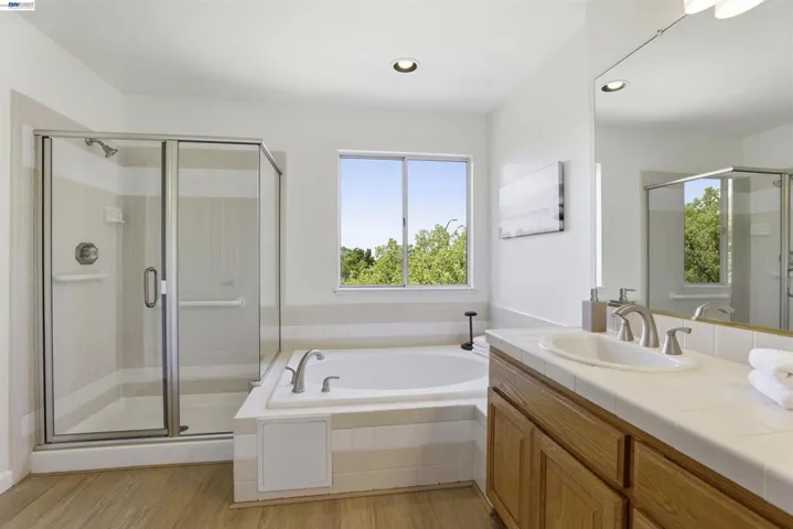 primary bath with separate tub and shower