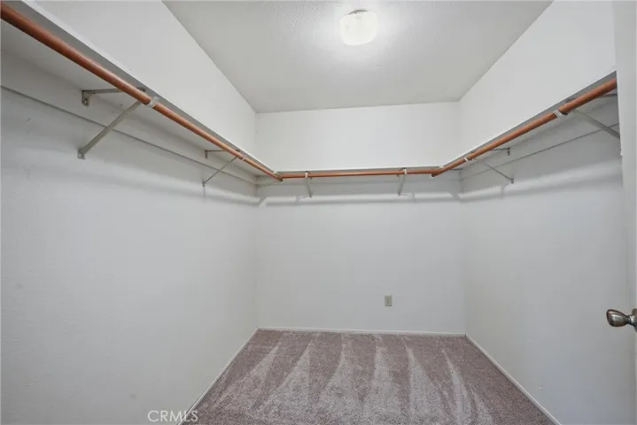 Primary bedroom walk in closet.