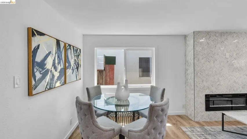 Herringbone pattern tile accent wall featuring a modern linear fireplace