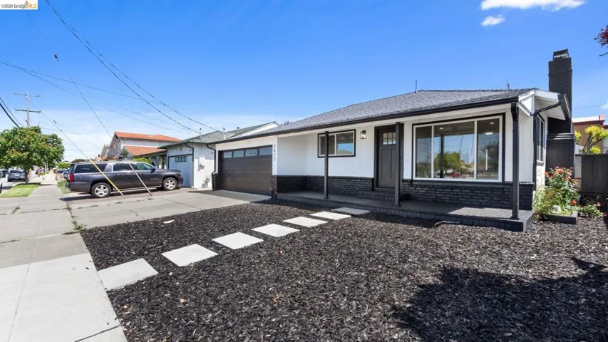 Contemporary single-story residence featuring a dark asphalt shingle roof and a contrasting black and white exterior