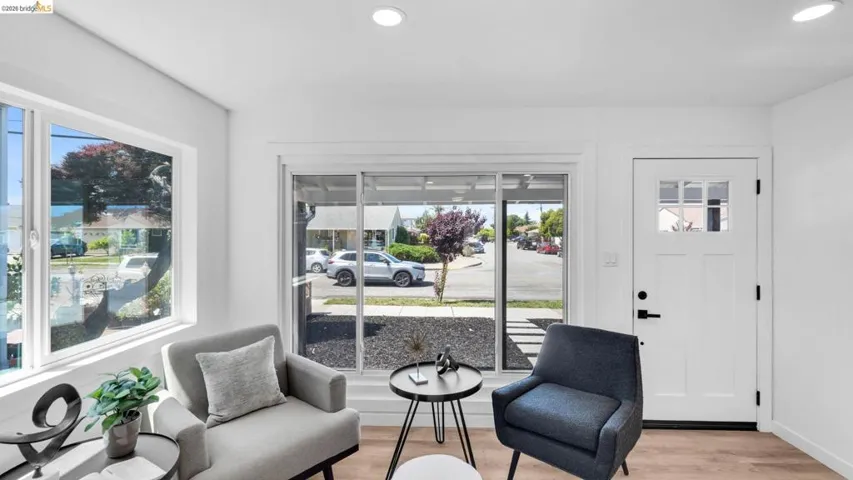 Bright interior space featuring wood-finish flooring, white walls, and recessed lighting