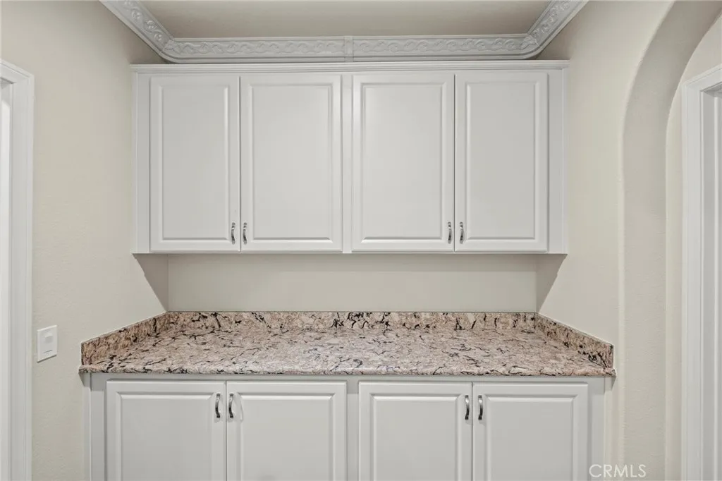 Cabinetry in Hallway with Granite Counters