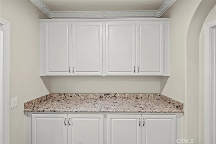 Cabinetry in Hallway with Granite Counters