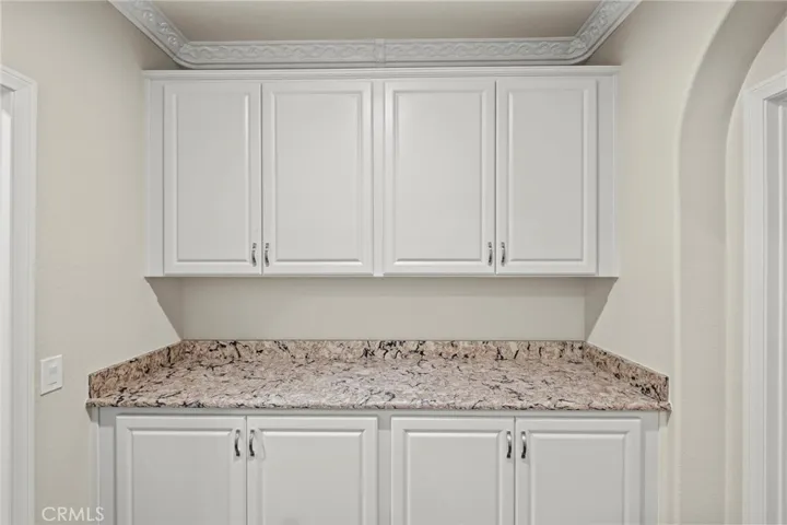 Cabinetry in Hallway with Granite Counters