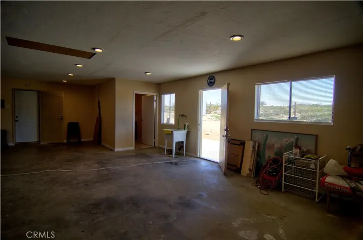The backdoor from the garage leads out to the backyard.