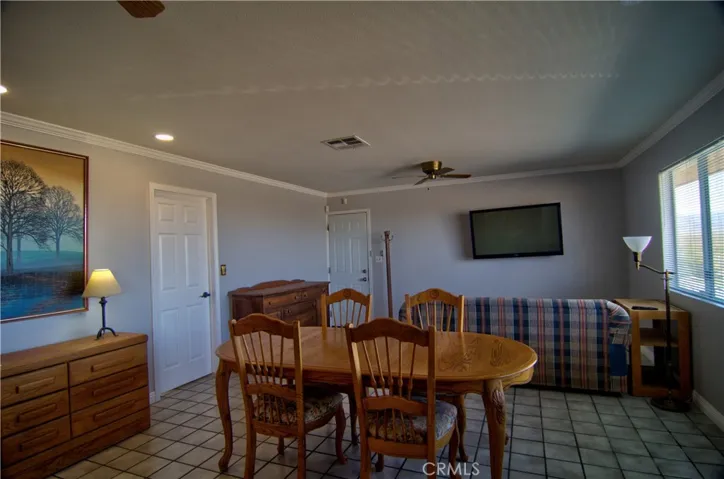 There is a large living room with a dining area
