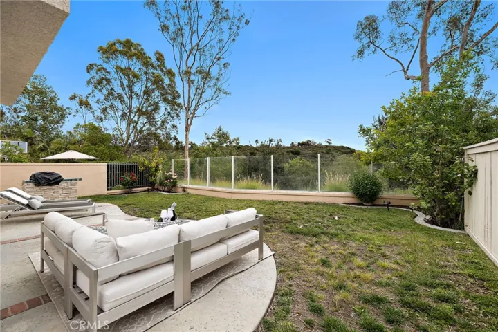 Spacious Backyard with Patio space and Grassy area with an peaceful view