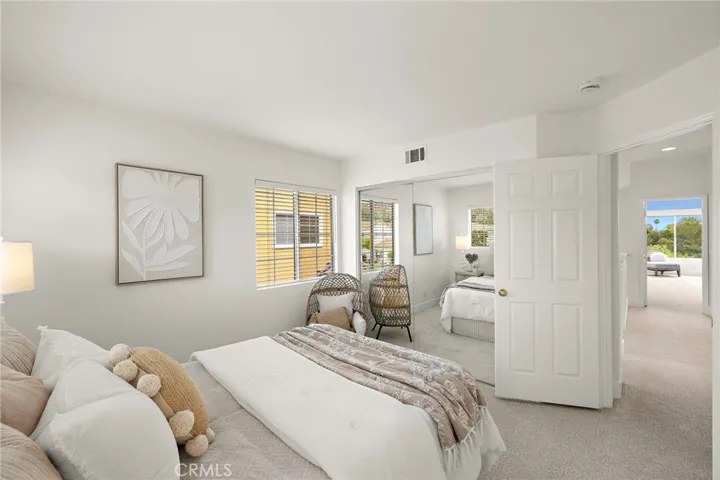 Bedroom with mirrored sliding closet doors