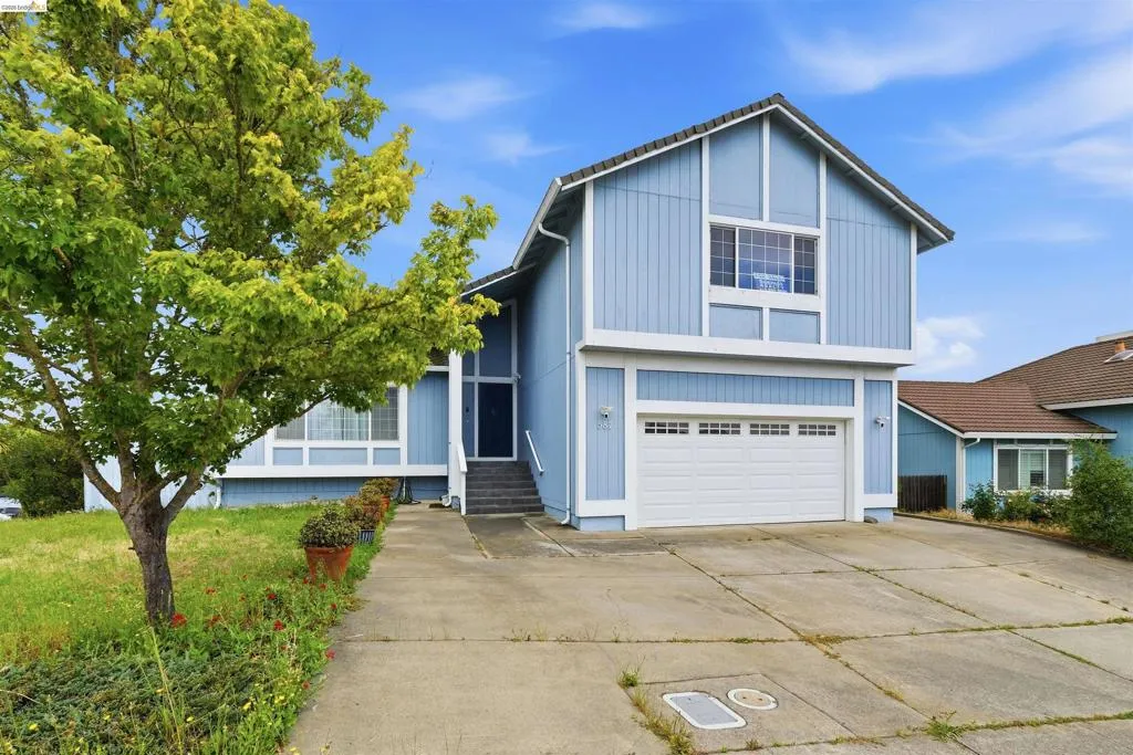 Two-story residence featuring light blue siding with white trim accents