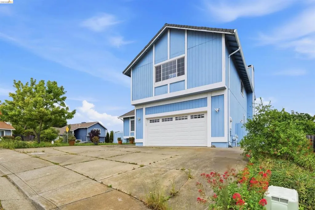 Two-story residence featuring blue siding with white trim accents