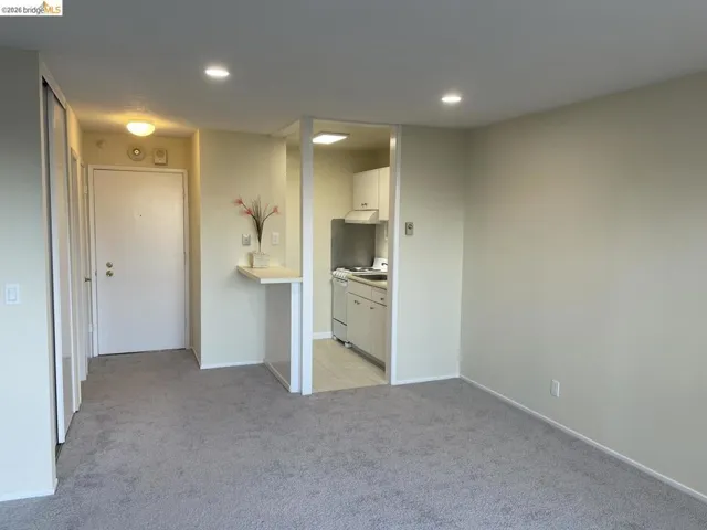 spare room featuring light carpet and recessed lighting
