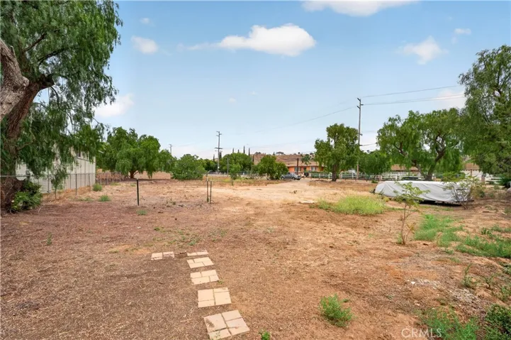 Fenced flat usable additional space for horses, stables, you name it! .98 acres total